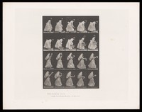 view A clothed woman picks up a basket then carries a parasol and waves a handkerchief. Collotype after Eadweard Muybridge, 1887.
