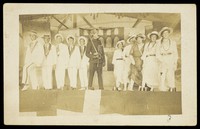 view Eleven sailors performing in a play on the Ark Royal. Photographic postcard, 191-.