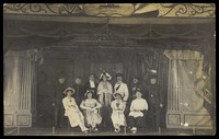 view Eleven men on a large stage set. Photographic postcard. 192-.