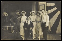 view Servicemen performing a play, in front of the stage. Photographic postcard. 191-.