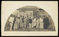 view Sailors with men in drag outside a building. Photographic postcard, 191-.