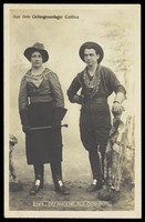 view British prisoners of war in cowboy and cowgirl costumes posing at a prisoner of war camp in Cottbus. Photographic postcard by P. Tharan, 191-.