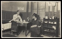view Two amateur actors, both in drag, having a drink on stage. Photographic postcard, ca. 1918.