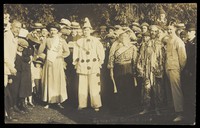 view People at Rickmansworth, Herts., some in drag, gather outside at a swimmming gala. Photographic postcard, 1908.