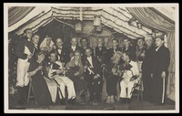 view German actors, some in drag, gather on stage at a party. Photographic postcard, 1930-45.