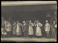 view Sailors, some in drag, stand on stage performing a scene. Photographic postcard, 191-.