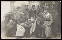 view British soldiers, two in drag, pose for a group portrait, in front of a detailed backdrop. Photographic postcard, 191-.