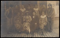 view British soldiers in France, one in drag, pose for a group portrait. Photographic postcard, 191-.