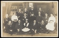 view Sailors, some in drag, posing for a group portrait within a highly-detailed stage set. Photographic postcard, 191-.