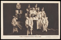 view British prisoners of war, one in drag, posing for "The Timbertown Follies", at a prisoner of war camp in Groningen. Process print, 191-.