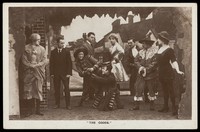 view Soldiers, some in drag, performing in the concert party "The Goods". Photographic postcard, 191-.