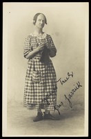 view Gus Garrick in drag as a pantomime dame.