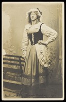 view Maitland Cecil Melville Wills posing in a black corset and heavy skirt.