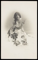 view A young man poses in a flowery dress.