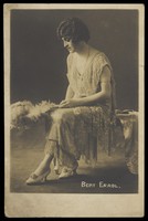 view Bert Errol in drag, wearing a light dress. Photographic postcard, 191-.