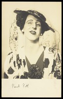 view Paul Pitt in drag, posing in flowery garments. Photographic postcard, 194-.