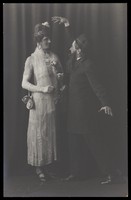 view Ralph Mellor in drag and another actor perform a scene in Trilby. Photographic postcard by L.S. Langfier, 192-.