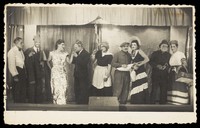 view Actors, some in drag, pose at a "French" concert party.