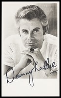 view Danny La Rue posing in a white t-shirt.