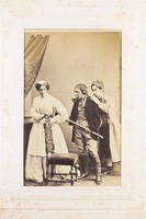 view Three men, one in drag, acting out a scene. Photograph, 189-.