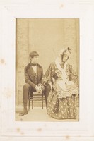 view Two men, one in drag, sitting next to each other. Photograph, 189-.