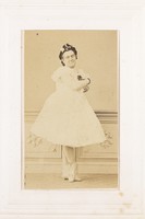 view A man in drag poses with his arms crossed, wearing a ballerina costume. Photograph, 189-.