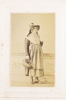 view A man in drag poses with a bonnet, basket and broom. Photograph, 189-.