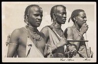 view Photograph of three Maasai men in three-quarters profile.