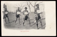 view Four African men competing in a walking race.