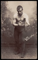 view A wrestler poses ready for combat. Photographic postcard, 19--.