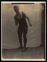 view A young man demonstrating a position in boxing. Photograph, 19--.