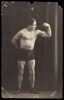 view A wrestler flexing his biceps. Photographic postcard, 19--.