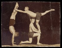 view Three male acrobats perform a routine. Photograph, 19--.