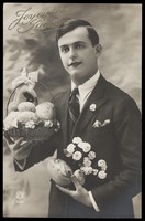 view A man offering Easter eggs and flowers. Photographic postcard, ca. 1920.