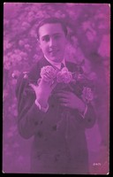 view A young man holding roses, engaging the viewer. Colour photographic postcard, 1928.