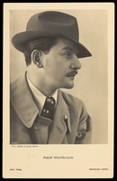 view Adolf Wohlbrück (Anton Walbrook), in profile, wearing a trilby. Photographic postcard by Bender & Jacobi, 193-.