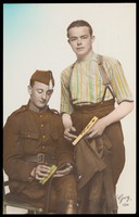 view Two Belgian soldiers cleaning their uniforms. Coloured photographic postcard, 192-.