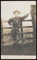 view A senior Scout poses next to a tree. Photographic postcard, ca. 1920.