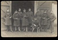 view Belgian soldiers posing with a dog. Photographic postcard, 191-.