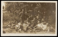 view Soldiers relaxing in a field. Photographic postcard, 191-.