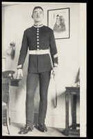 view A Royal Fusilier standing holding a sword in a domestic setting, ca. 192-. Photograph, 195-.