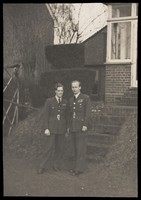 view Michael Simon and Gerald Fidler, two air force officers, together in a garden. Photograph, 1943.