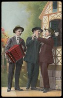 view Two Dutch men dancing together, accompanied by an accordionist. Colour photographic postcard, 190-.