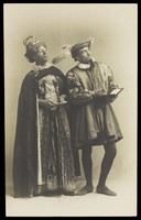 view Actors in pantomime in Brighton: S. West playing King Robert of Remlaf and H. Taylor in drag as Queen Aggie of Remlaf. Photographic postcard.