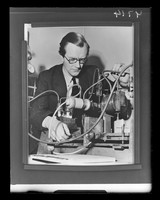 view Photograph referenced as "Reproduction of Maurice Wilkins at work on the x-ray apparatus. B.B.C. [British Broadcasting Corporation]"