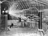 view Nikola Tesla, with his equipment for producing high-frequency alternating currents.