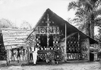 view M0001016: Man standing in front of a decorated structure