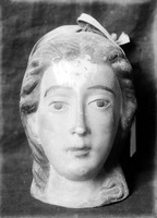 view M0001513: Photograph of a wax ex-voto of a human head (possibly female) with markings on the forehead