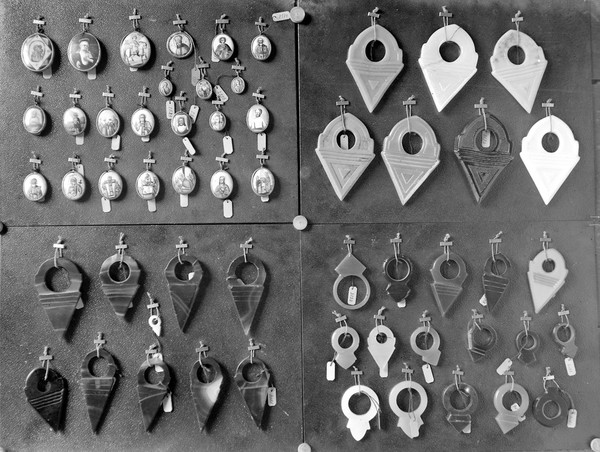 M0001523: Photograph of four groups of mounted religious medallions and carved stone amulets