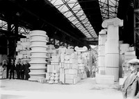 view M0002519: Clients and workers stood next to stonework for the Wellcome Research Institute Building